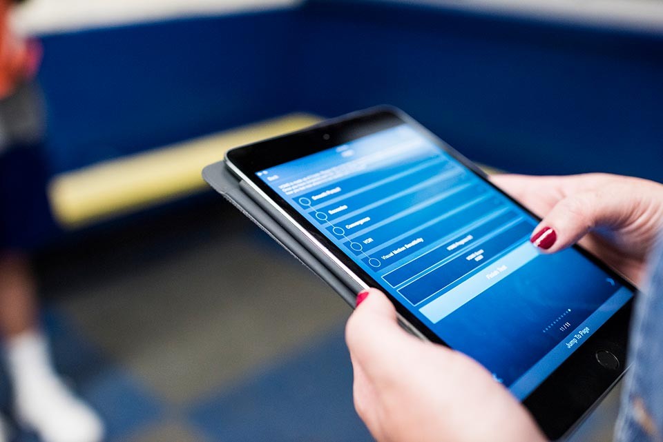 Image of Kerry's hands holding a tablet