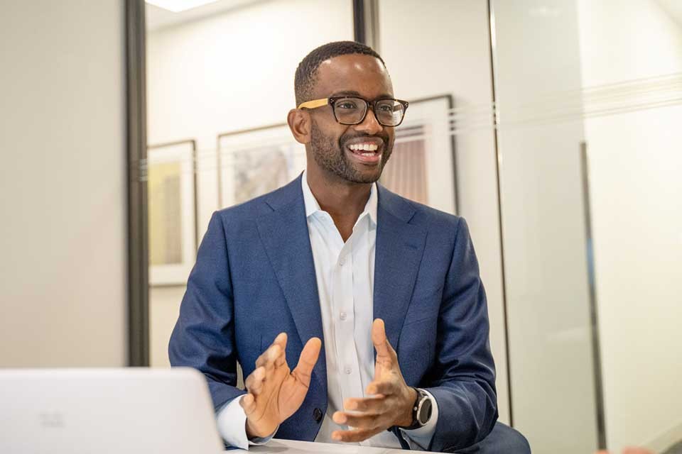 Image of Matthew Colphon explaining something sitting in an office