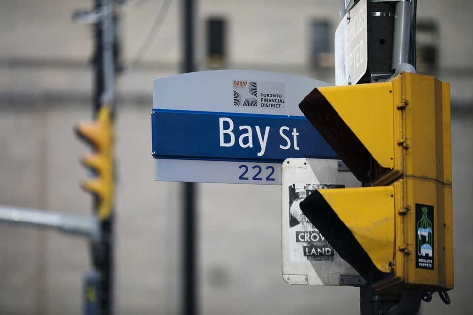 closeup image of street sign "Bay Street" in downtown Toronto