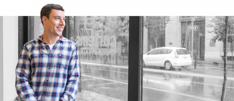 Jordan leaning against storefront window