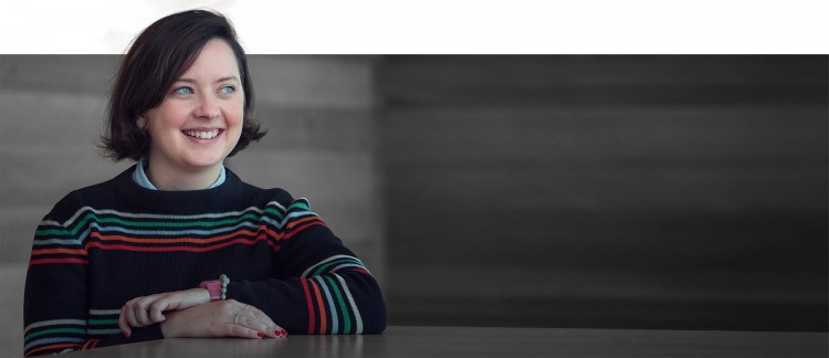 Image of Kate Hyde sitting at a wooden table