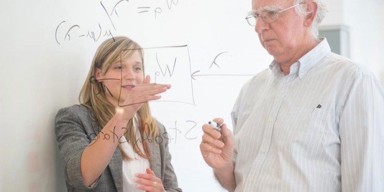 Image of professor and student writing on glass