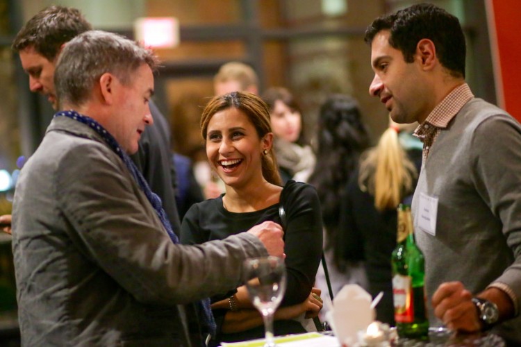3 alum laughing over glasses of wine