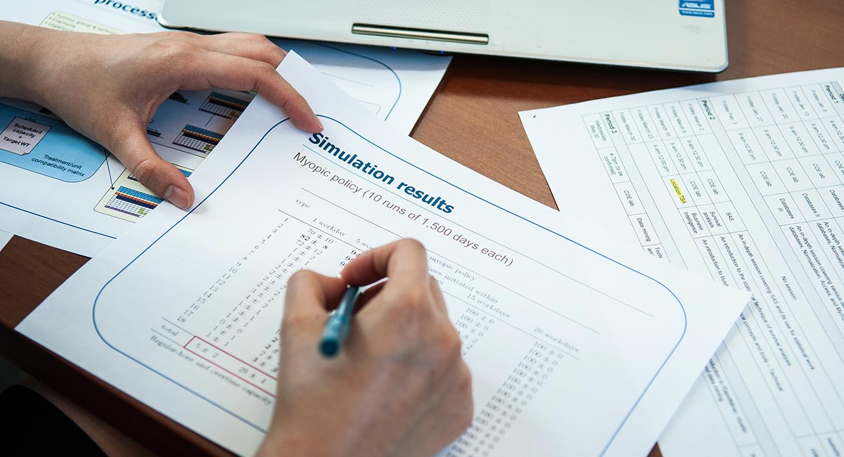 Image of hand writing on documents